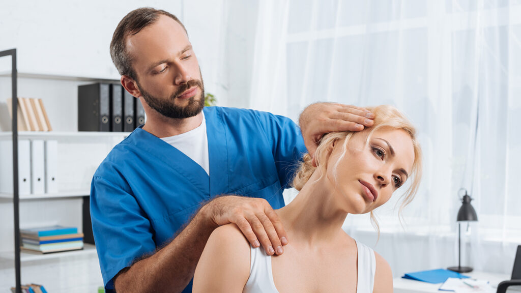 A chiropractor adjusting a woman with lupus in the office.